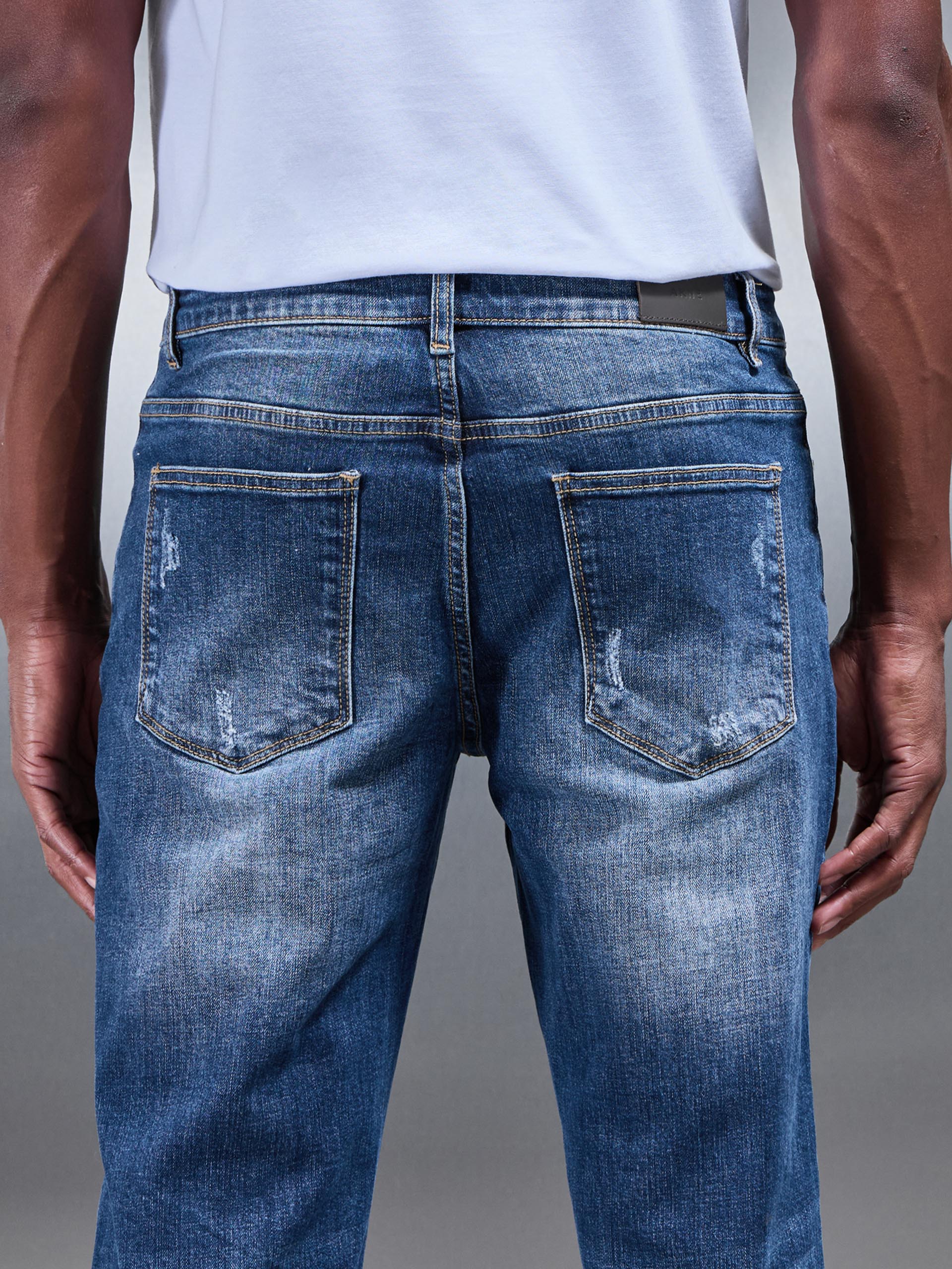 Distressed Straight Leg Denim Jeans in Mid Blue