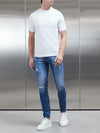 Distressed Denim Jeans in Mid Blue